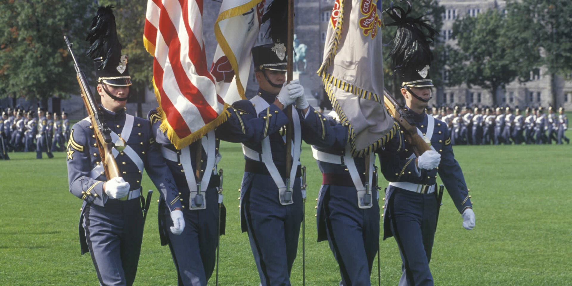 A group of men in uniform holding flags.